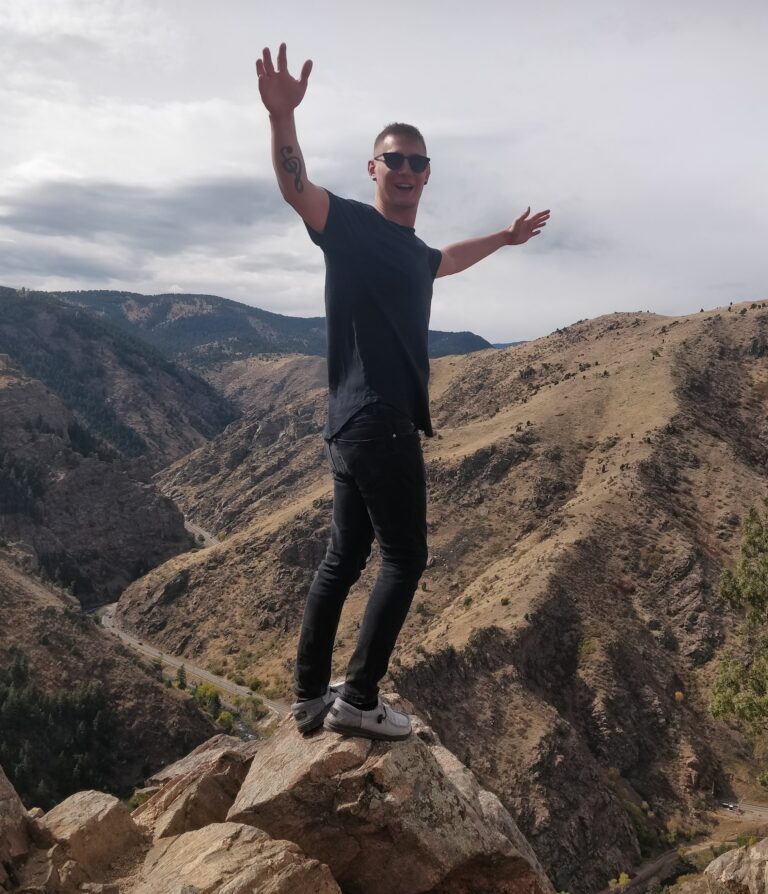 Alex Pipp standing on top of a mountain
